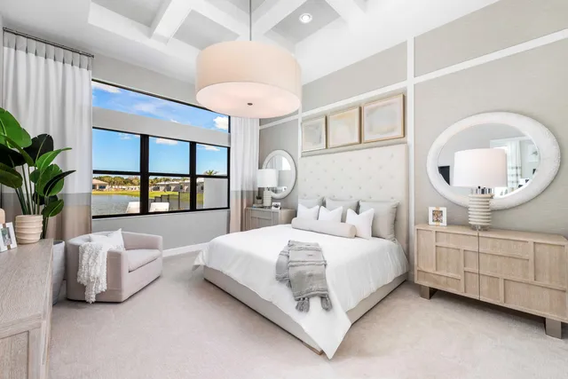 a bedroom with a large bed and a chandelier