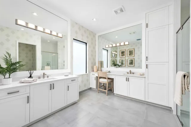 a large white bathroom with a granite countertop sink mirror and a bathtub