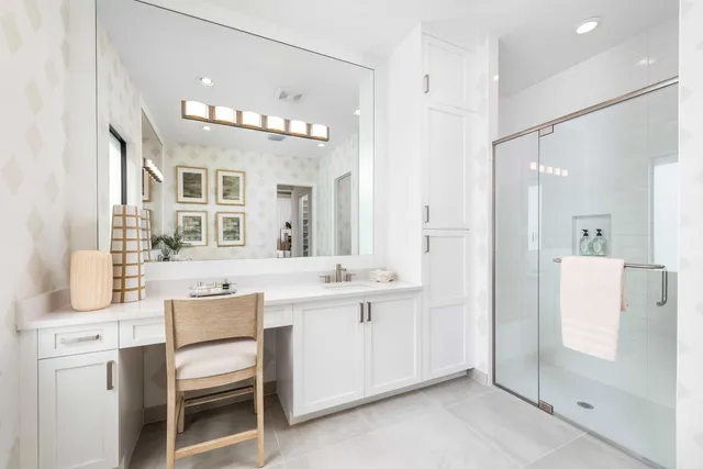 a spacious bathroom with a sink a mirror and a shower