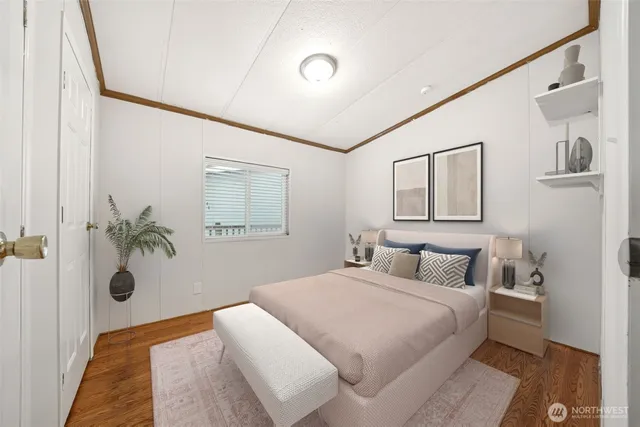 a bedroom with a bed and a painting on the wall