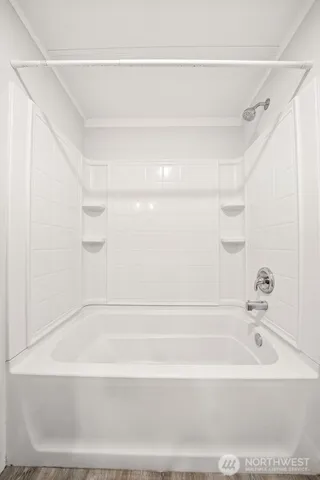 a bathroom with a bathtub and a shower
