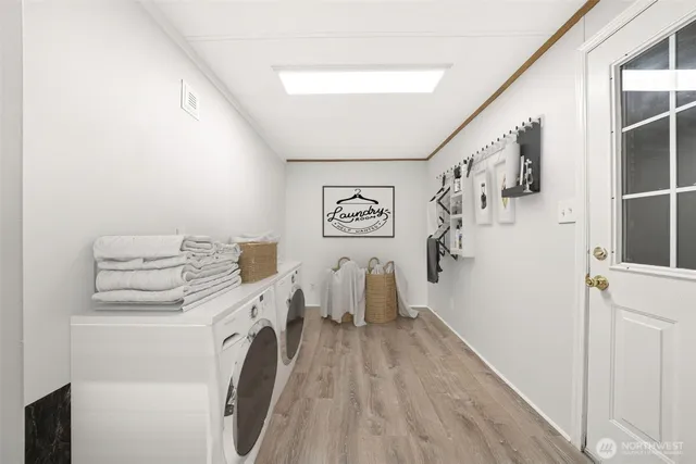 a view of a hallway with washer and dryer