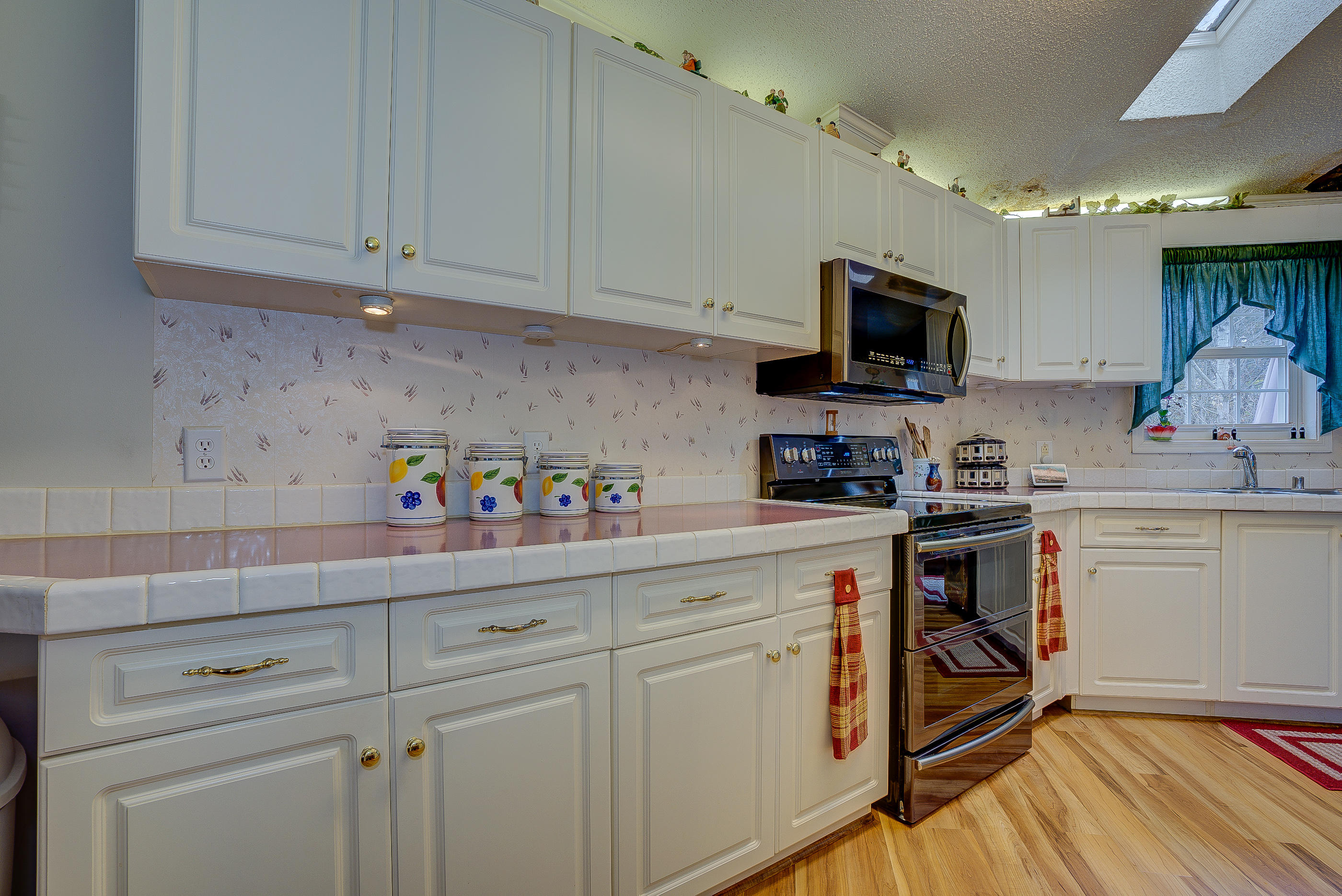 3339 Quarles Road Thaxton, VA 24174 - Photo 14 of 28 a kitchen with stainless steel appliances granite countertop a sink a stove a microwave and cabinets