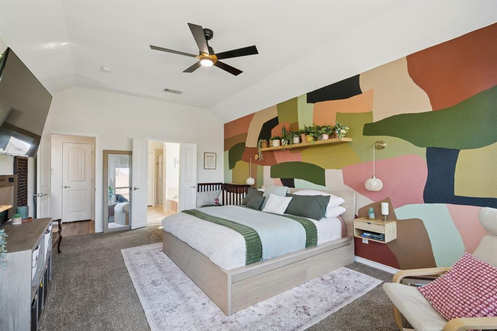 1326 White Water Lane Rockwall, TX 75087 - Photo 13 of 34 a bedroom with a bed a lamp and a flat screen tv