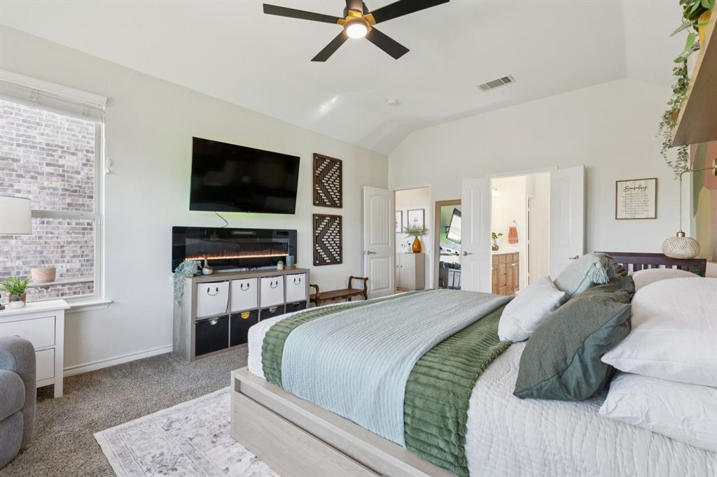 1326 White Water Lane Rockwall, TX 75087 - Photo 14 of 34 a bedroom with a bed and a flat screen tv
