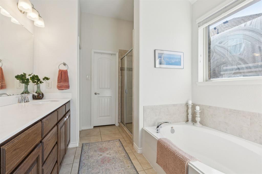 1326 White Water Lane Rockwall, TX 75087 - Photo 15 of 34 a spacious bathroom with a tub sink and mirror
