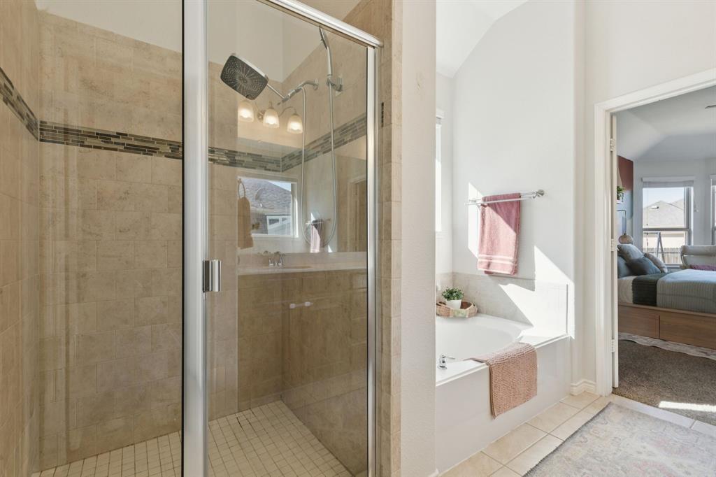 1326 White Water Lane Rockwall, TX 75087 - Photo 16 of 34 a bathroom with a tub shower and mirror