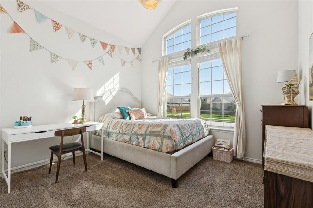 1326 White Water Lane Rockwall, TX 75087 - Photo 17 of 34 a bedroom with a bed and a table