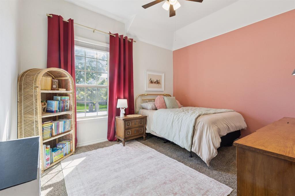 1326 White Water Lane Rockwall, TX 75087 - Photo 18 of 34 a bedroom with a bed and a book shelf