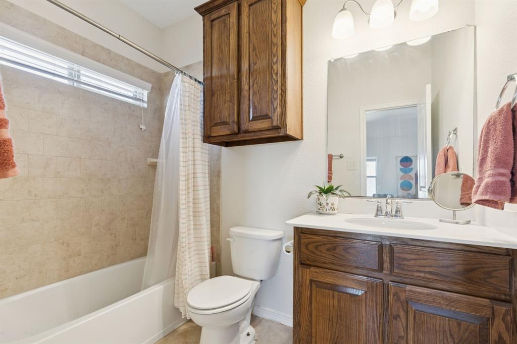 1326 White Water Lane Rockwall, TX 75087 - Photo 23 of 34 a bathroom with a sink vanity mirror and toilet