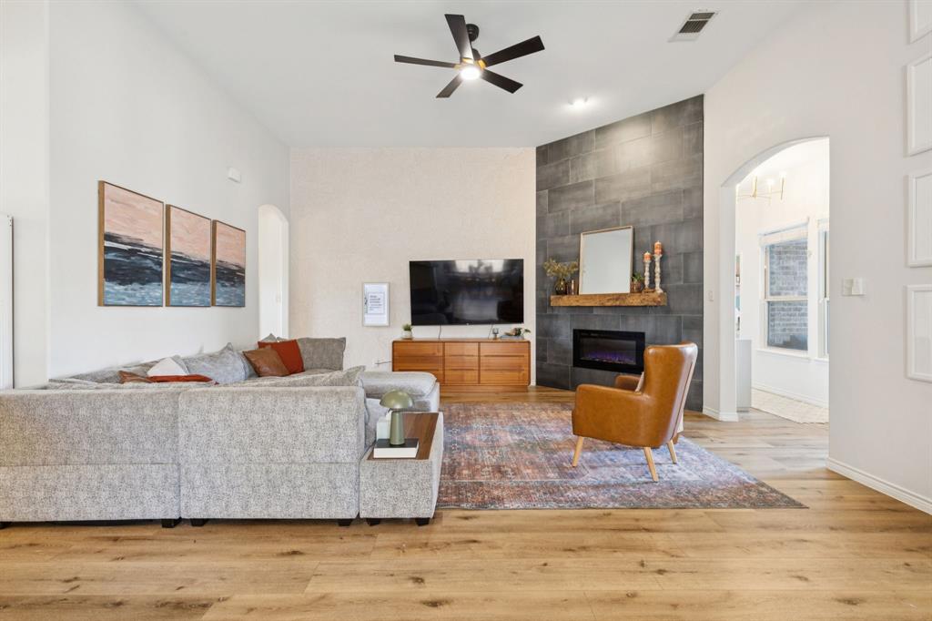 1326 White Water Lane Rockwall, TX 75087 - Photo 6 of 34 a living room with furniture and a flat screen tv