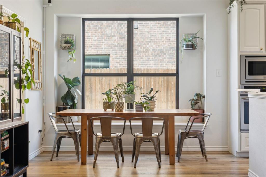 1326 White Water Lane Rockwall, TX 75087 - Photo 10 of 34 a dining room with furniture potted plants and wooden floor