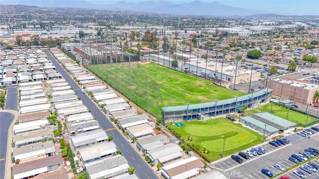 an aerial view of a tennis ground and a cars park