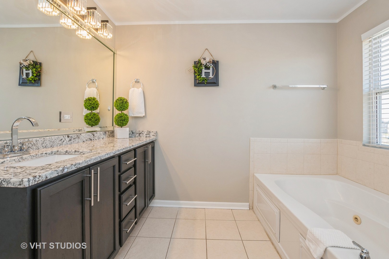 82 Stephens Matteson, IL 60443 - Photo 19 of 33 a bathroom with a granite countertop sink a large mirror and a bathtub