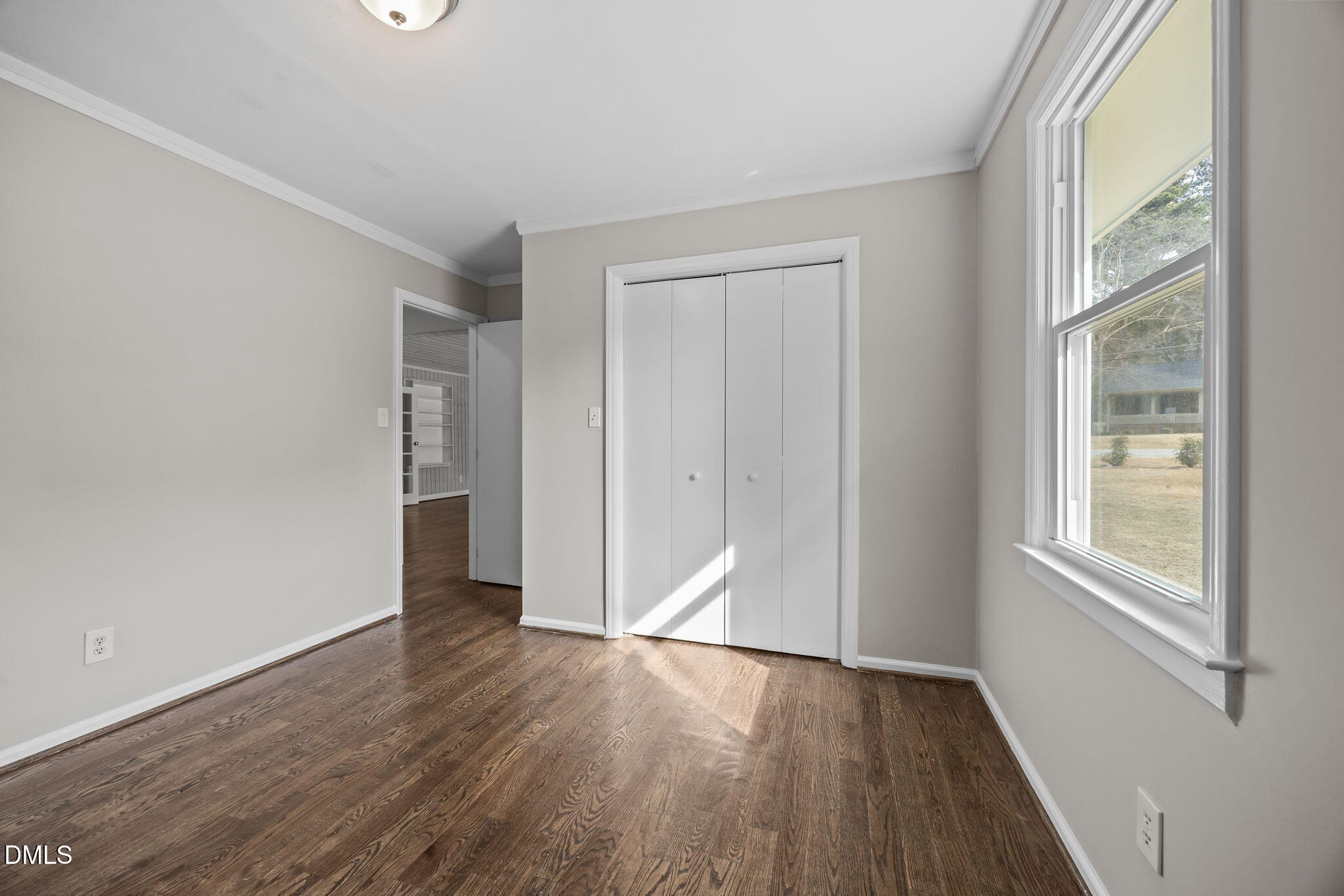 700 Woodland Road Raleigh, NC 27603 - Photo 12 of 35 an empty room with wooden floor and windows