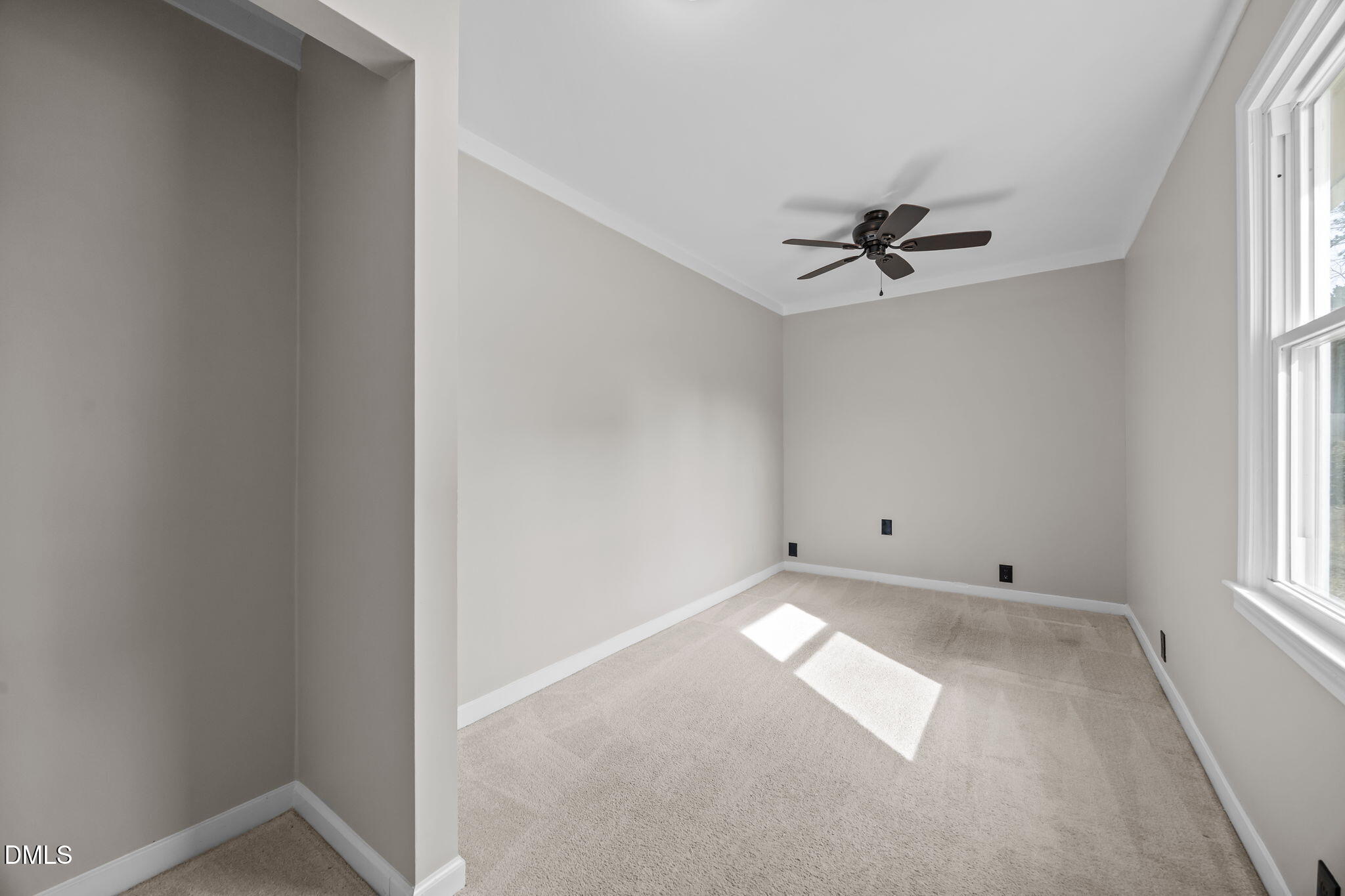 700 Woodland Road Raleigh, NC 27603 - Photo 13 of 35 an empty room with windows and fan