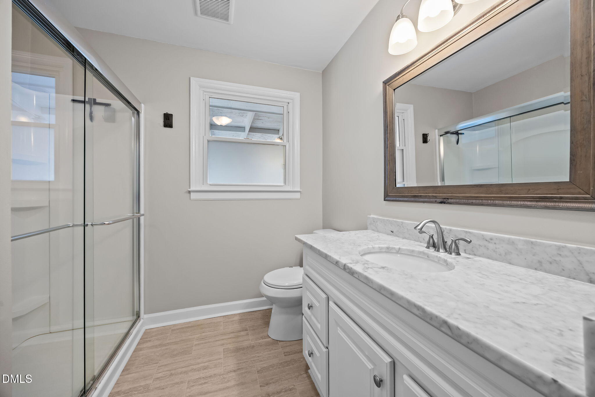 700 Woodland Road Raleigh, NC 27603 - Photo 17 of 35 a bathroom with a sink and a mirror