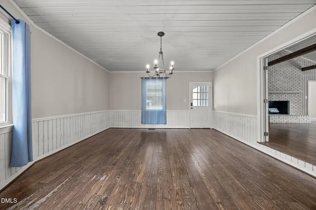 a view of a livingroom with wooden floor and a ceiling fan
