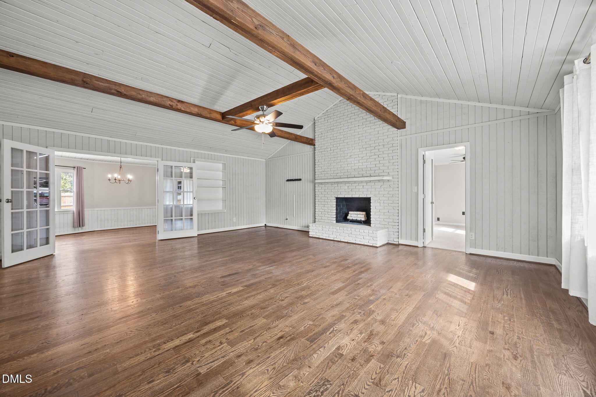 700 Woodland Road Raleigh, NC 27603 - Photo 6 of 35 a view of empty room with wooden floor and fireplace