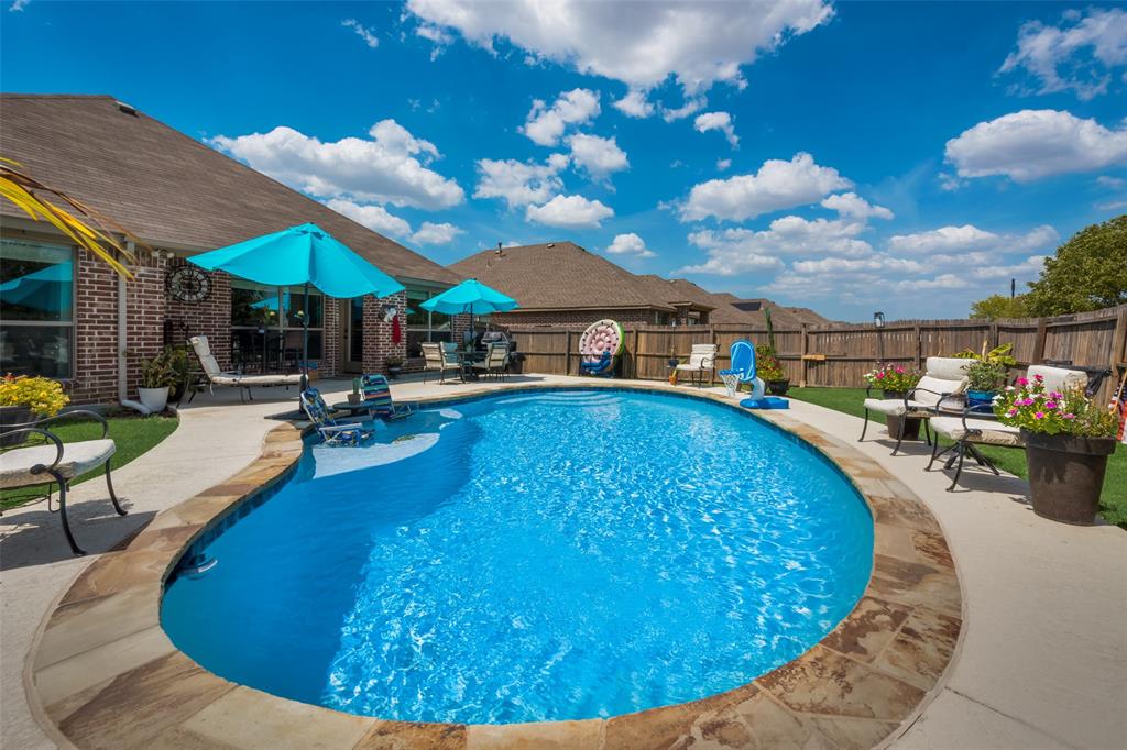 a view of a swimming pool with lounge chairs