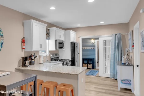 a kitchen with stainless steel appliances granite countertop a refrigerator and a sink