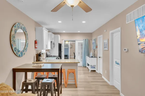 a kitchen with white cabinets white stainless steel appliances and sink