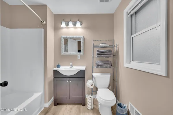 a bedroom with furniture and a large window