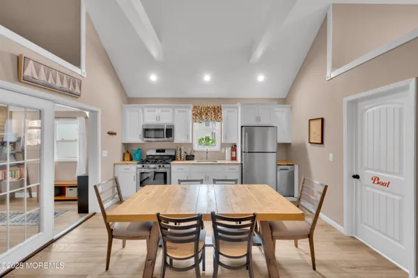 a kitchen with a refrigerator and a stove top oven