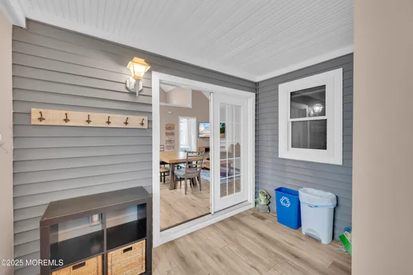 a kitchen with stainless steel appliances a dining table chairs refrigerator and microwave