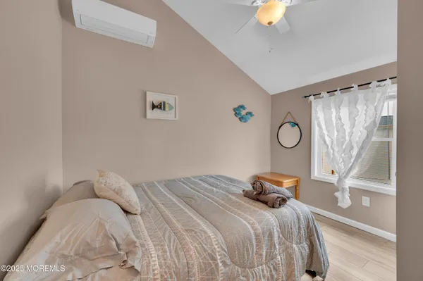 a view of a bedroom with a bed and a window