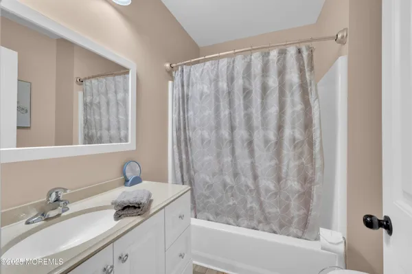 a bedroom with a bed and a table with wooden floor