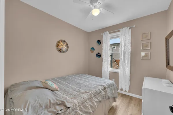 a bedroom with a bed and a large mirror