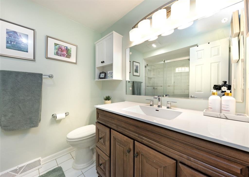 1267 Fall Lane Irwin, PA 15642 - Photo 13 of 22 a bathroom with a sink a toilet and shower