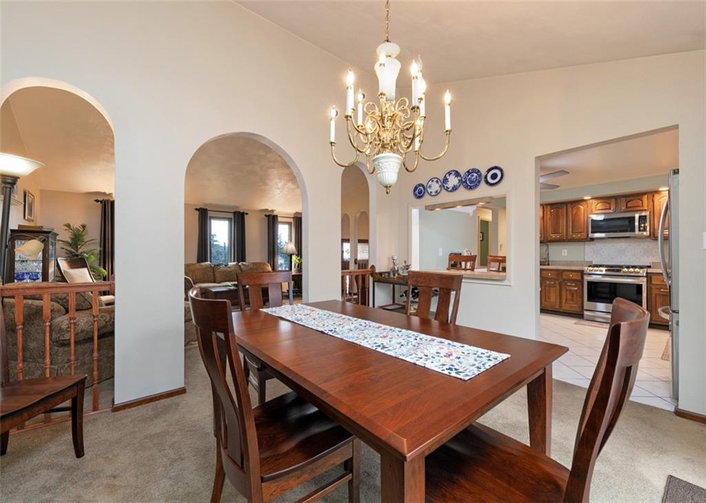 1267 Fall Lane Irwin, PA 15642 - Photo 8 of 22 a view of a dining room with furniture a chandelier and wooden floor