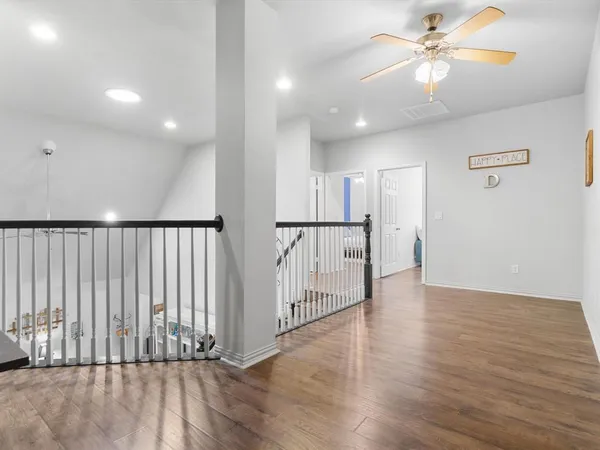 a view of a hallway with wooden floor