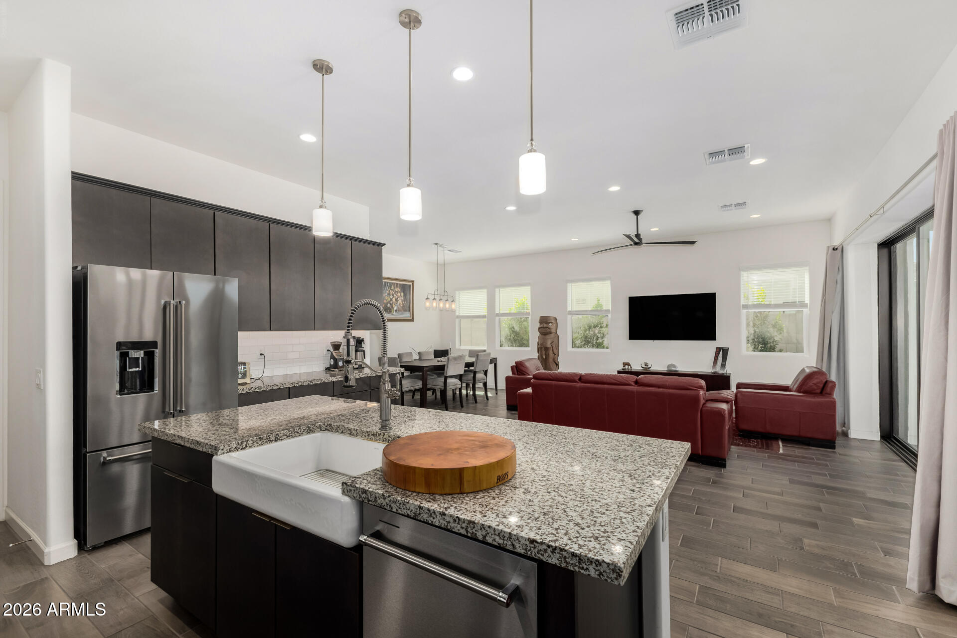 15544 South 181st Lane Goodyear, AZ 85338 - Photo 11 of 46 a kitchen with kitchen island granite countertop a sink stove and refrigerator