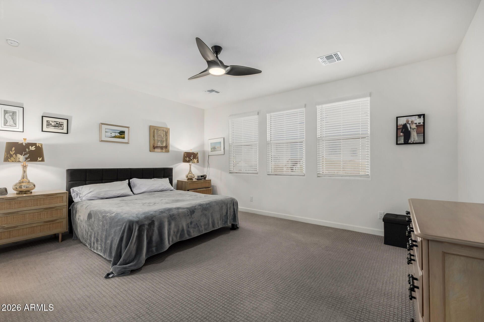 15544 South 181st Lane Goodyear, AZ 85338 - Photo 14 of 46 a spacious bedroom with a bed and a window