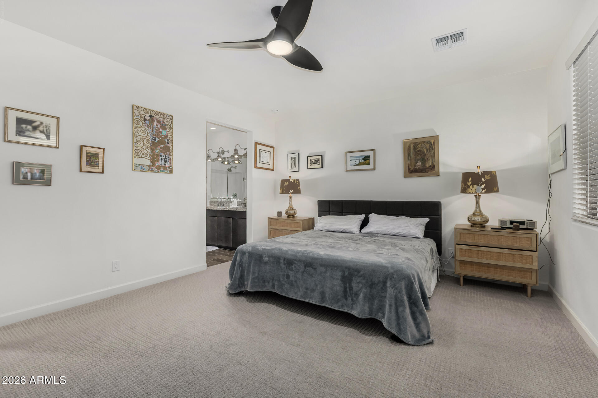 15544 South 181st Lane Goodyear, AZ 85338 - Photo 15 of 46 a spacious bedroom with a bed and ceiling fan