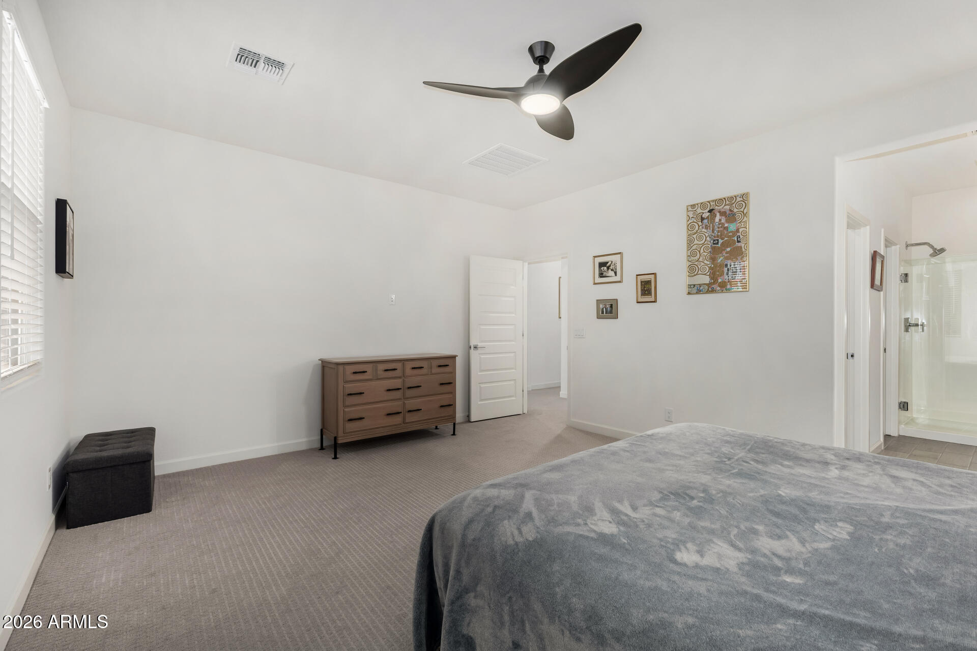 15544 South 181st Lane Goodyear, AZ 85338 - Photo 16 of 46 a bedroom with a bed and a ceiling fan