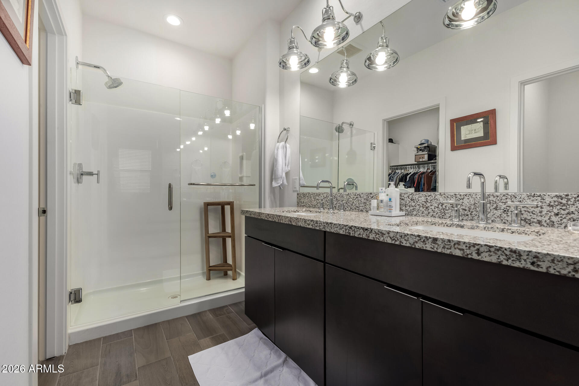15544 South 181st Lane Goodyear, AZ 85338 - Photo 17 of 46 a bathroom with a granite countertop sink a large mirror and shower