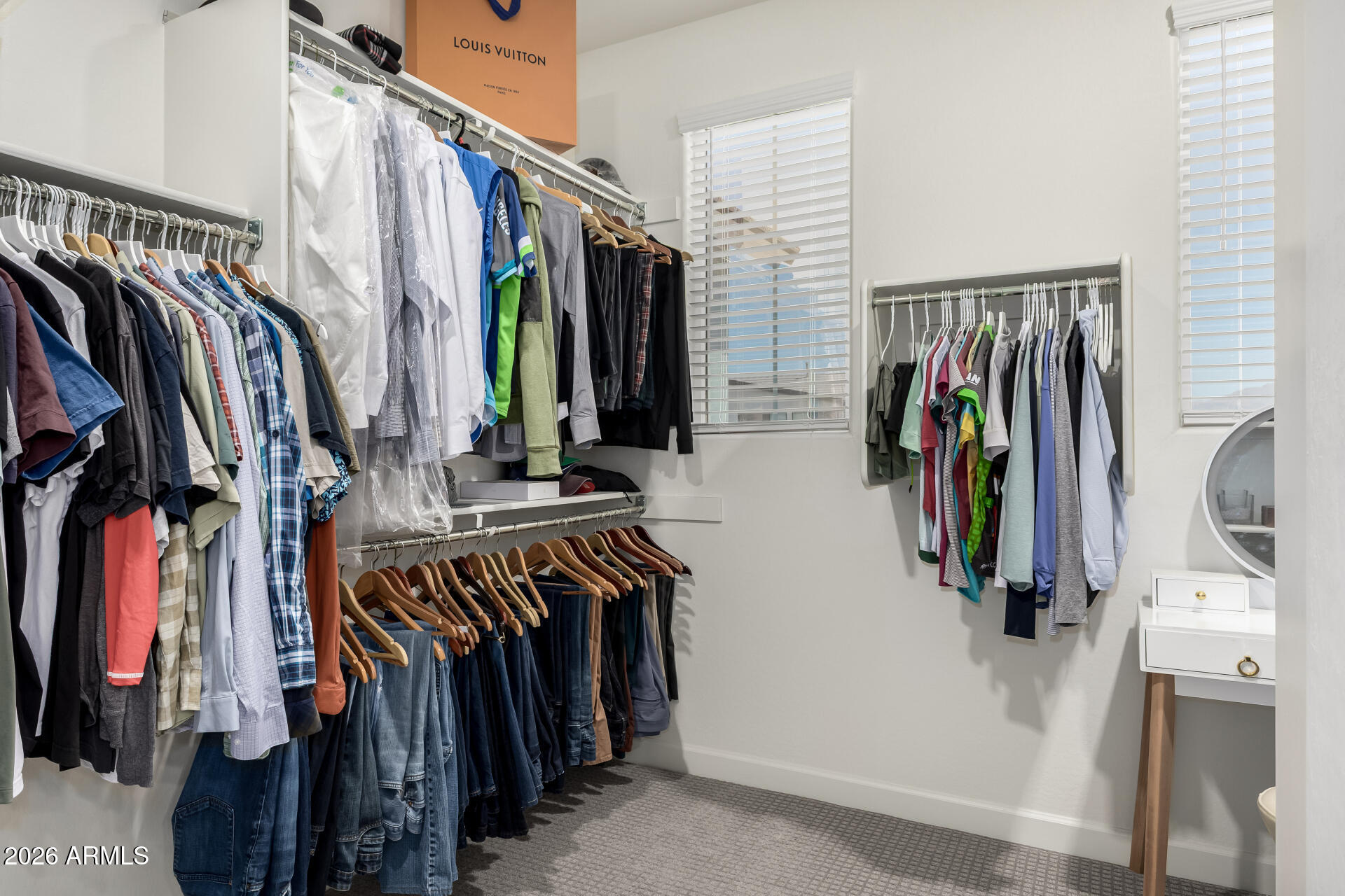 15544 South 181st Lane Goodyear, AZ 85338 - Photo 18 of 46 a view of walk in closet with clothes and shoes