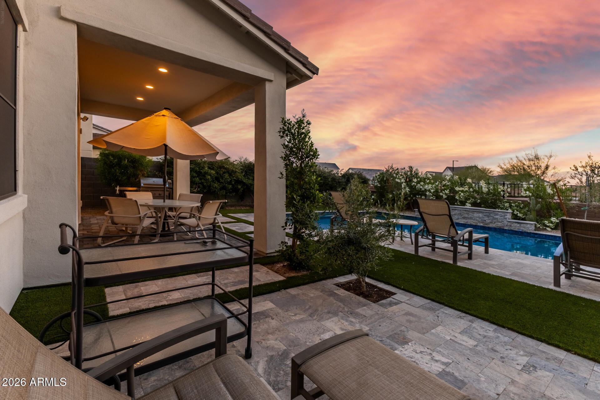 15544 South 181st Lane Goodyear, AZ 85338 - Photo 32 of 46 a swimming pool with outdoor seating and a garden