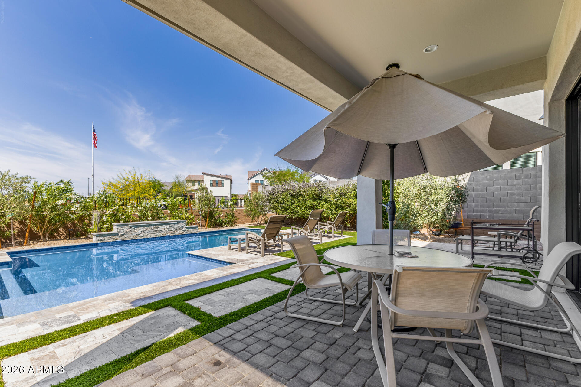 15544 South 181st Lane Goodyear, AZ 85338 - Photo 34 of 46 a view of a patio with chairs and table under an umbrella
