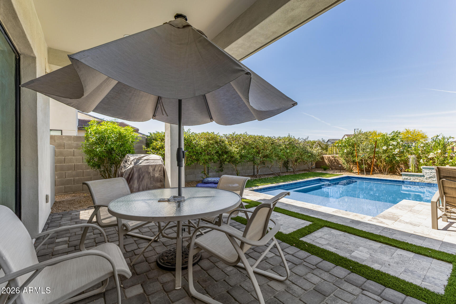 15544 South 181st Lane Goodyear, AZ 85338 - Photo 35 of 46 a view of patio with table and chairs under an umbrella