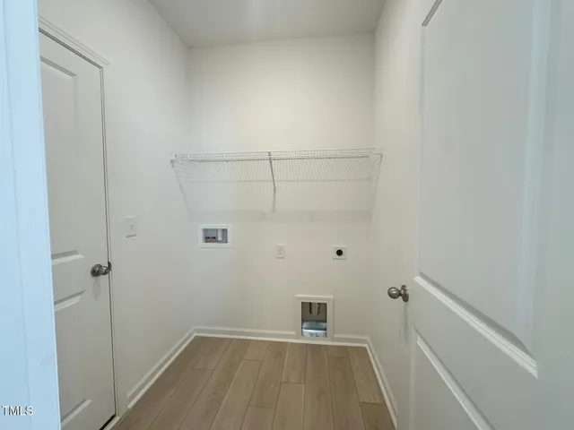 a view of kitchen with stainless steel appliances granite countertop a sink refrigerator and cabinets