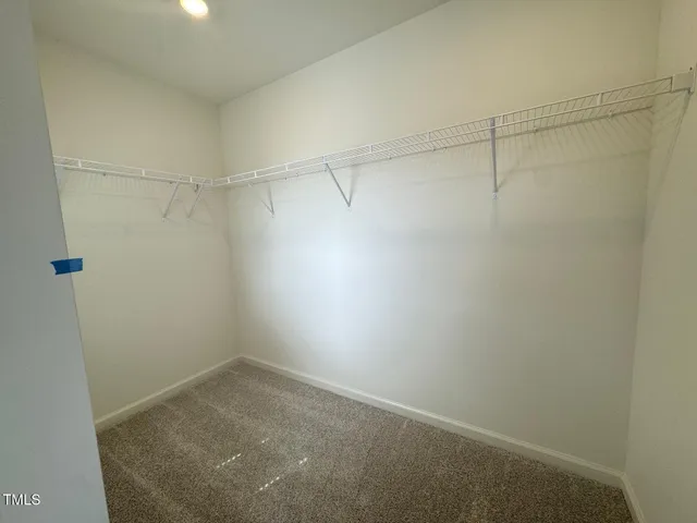 an empty room with a empty space and windows