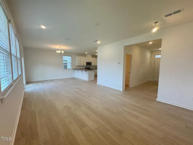 a view of a hallway with wooden floor and entryway