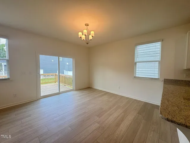 a view of a kitchen with a sink and a refrigerator
