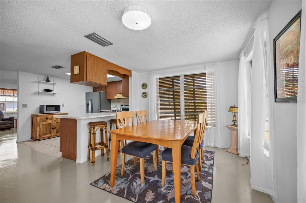 901 Ponderosa Road Venice, FL 34293 - Photo 20 of 33 a dining room with furniture and wooden floor