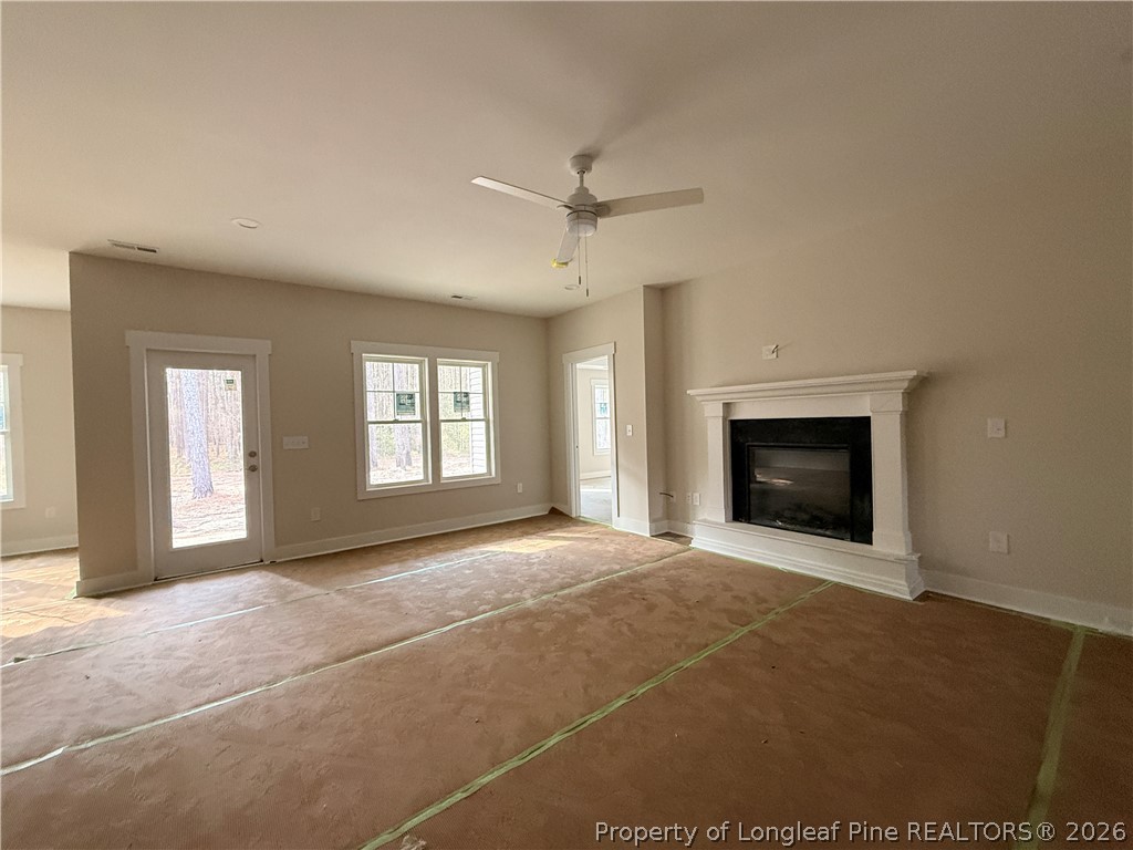 309 Elijah Way Vass, NC 28394 - Photo 6 of 8 a view of an empty room with a fireplace and a window